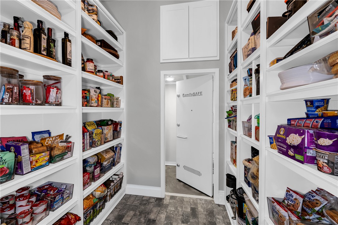 3510 Copper Ridge Road Rogers, AR 72756 - Photo 53 of 58 Spacious pantry featuring extensive shelving for storage, a white door, and grey flooring