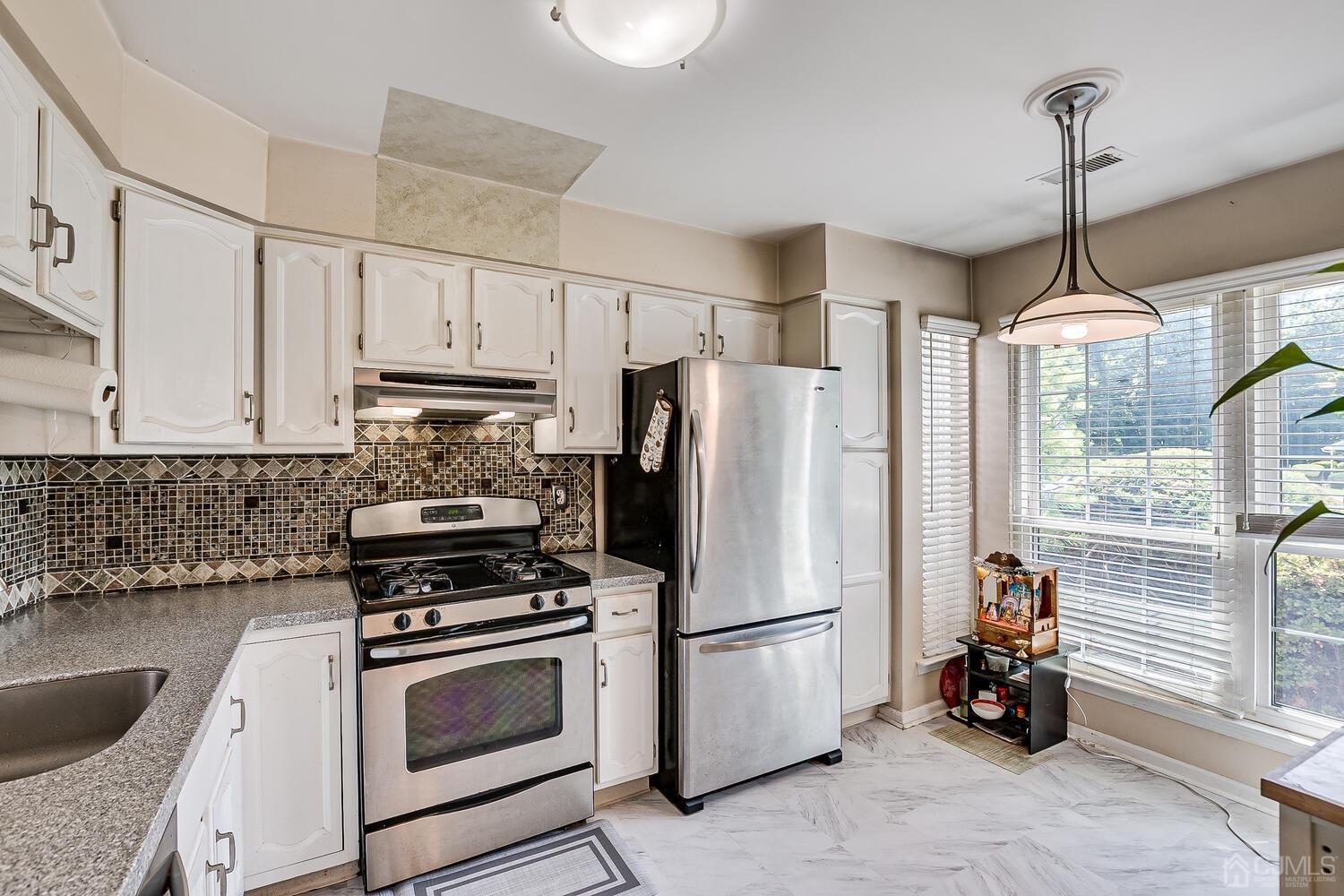 1005 Maplecrest Road Edison, NJ 08820 - Photo 15 of 48 a kitchen with stainless steel appliances a refrigerator sink and cabinets