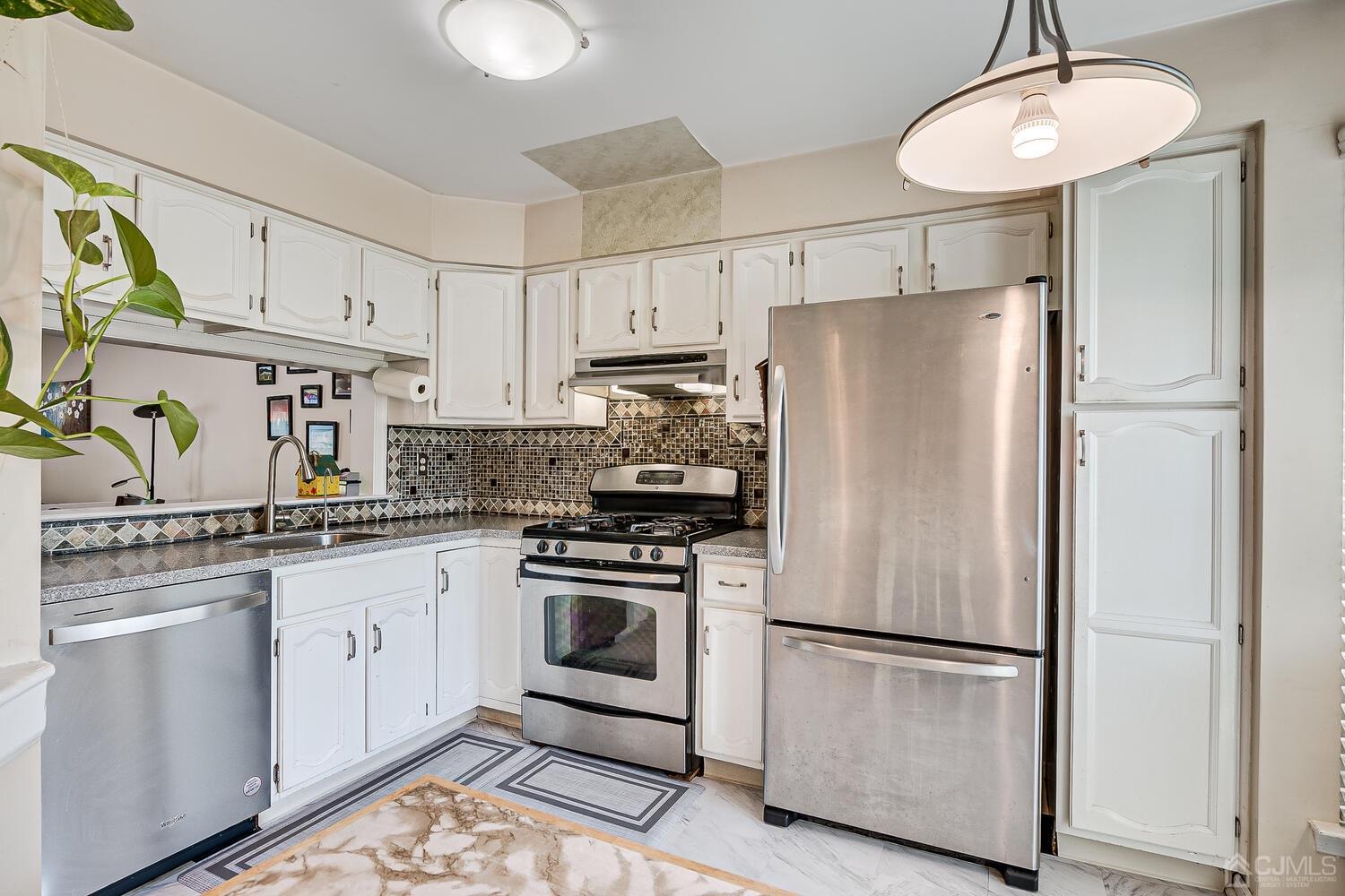1005 Maplecrest Road Edison, NJ 08820 - Photo 16 of 48 a white refrigerator freezer and a stove in a kitchen