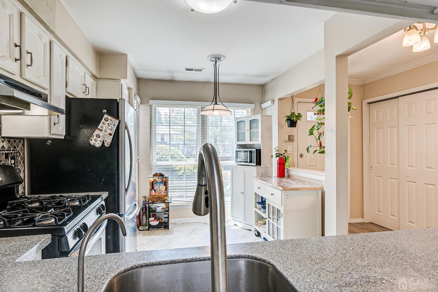 1005 Maplecrest Road Edison, NJ 08820 - Photo 20 of 48 a kitchen with stainless steel appliances granite countertop a sink dishwasher stove and refrigerator