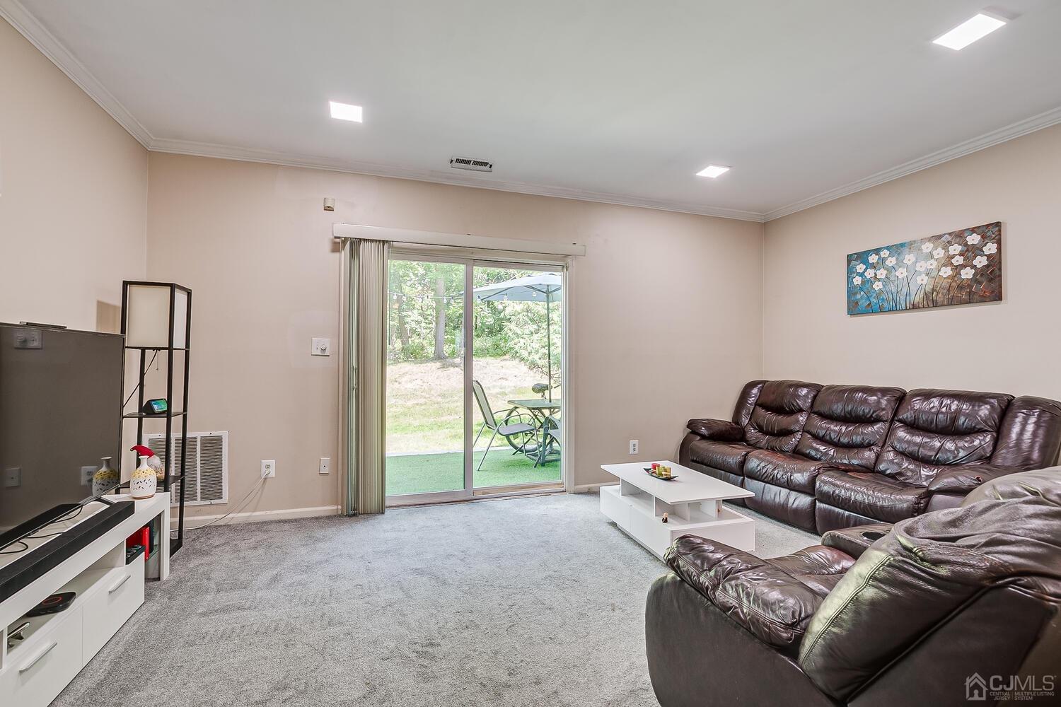 1005 Maplecrest Road Edison, NJ 08820 - Photo 26 of 48 a living room with furniture and a flat screen tv