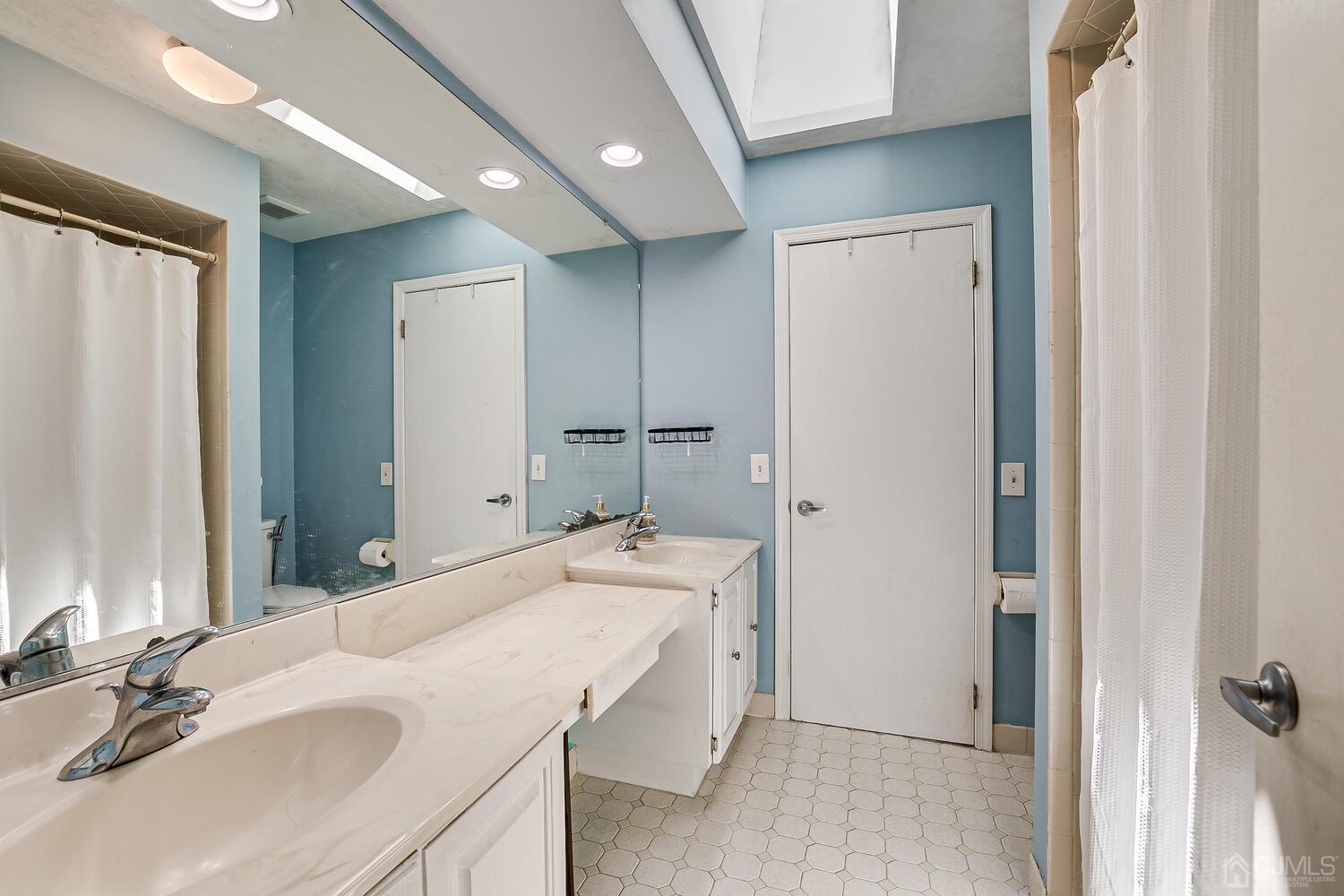 1005 Maplecrest Road Edison, NJ 08820 - Photo 34 of 48 a bathroom with a sink and a mirror