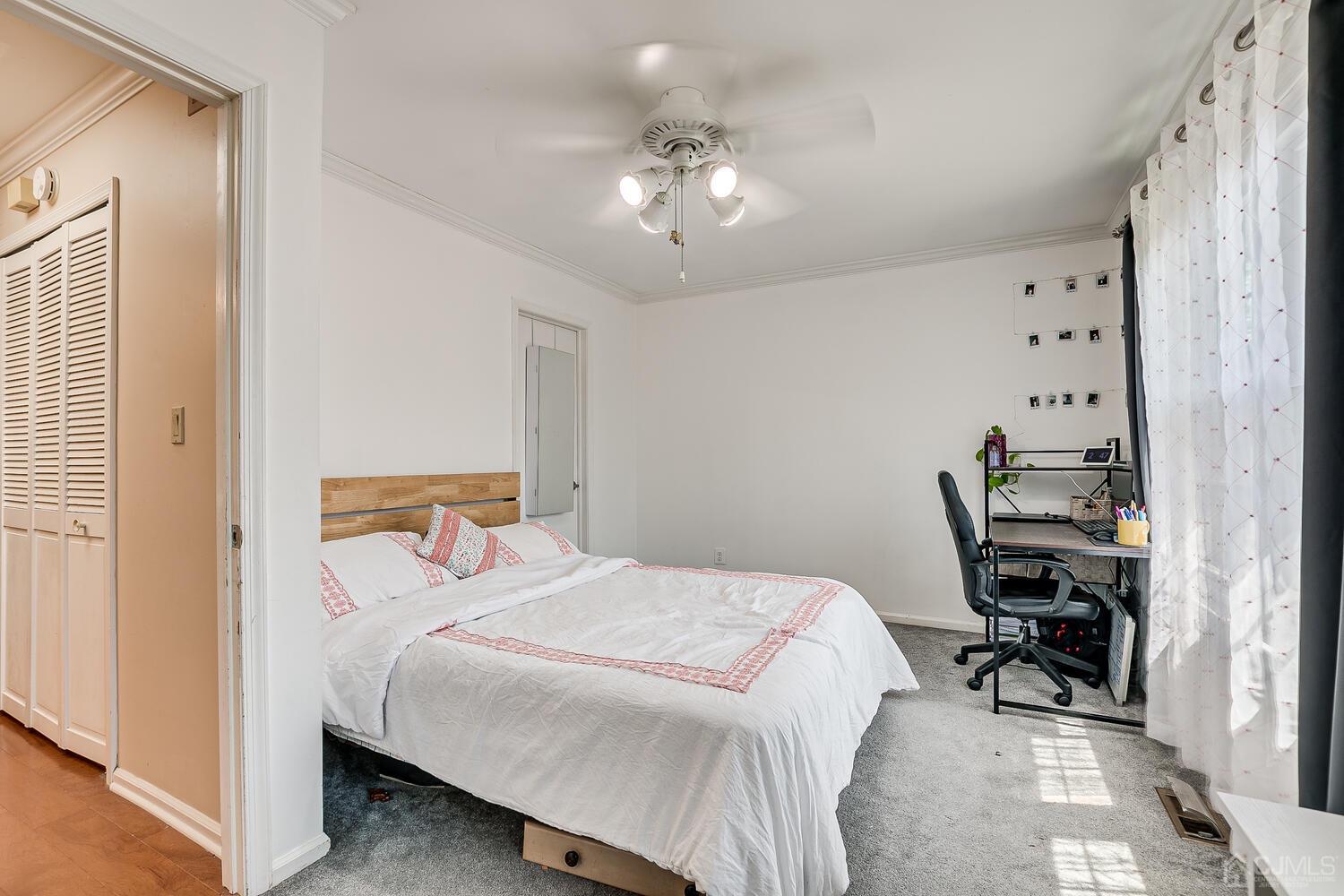 1005 Maplecrest Road Edison, NJ 08820 - Photo 36 of 48 a bedroom with a bed and a chandelier