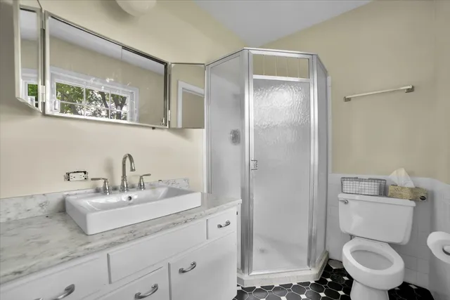 a bathroom with a toilet a sink and a mirror