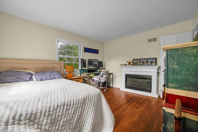 a bedroom with a bed and a fireplace