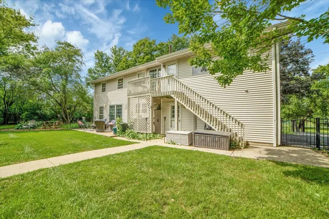 a view of a house with a yard and sitting area