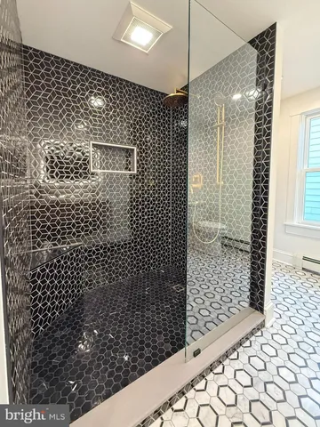 a bathroom with a double vanity sink mirror and toilet
