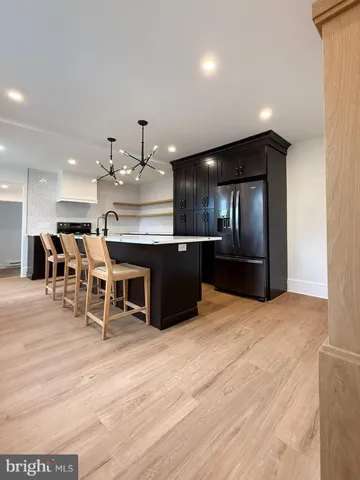 a large kitchen with a table and chairs