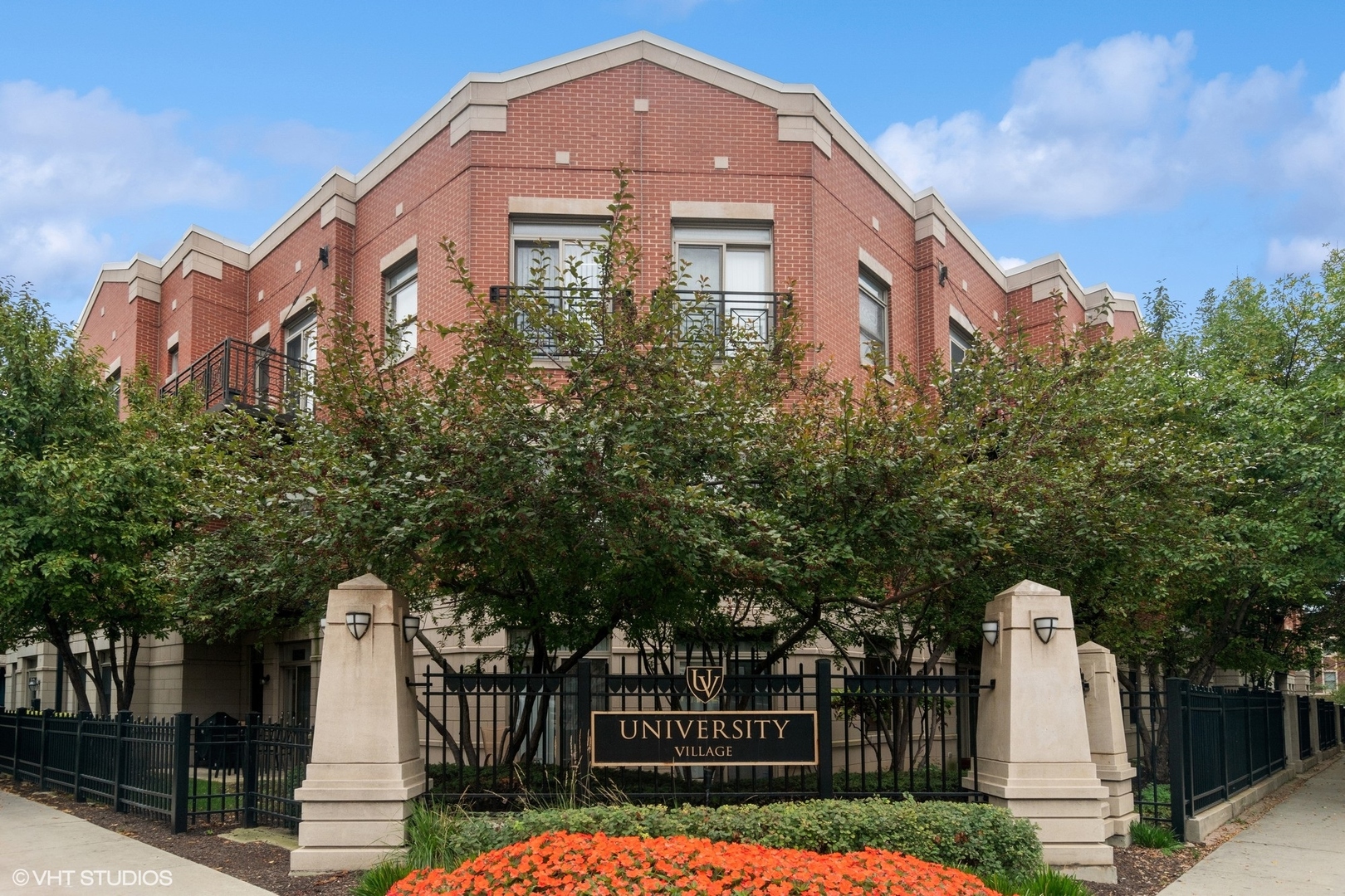 1451 South Halsted Street, Unit 2A Chicago, IL 60607 - Photo 1 of 10 a front view of a residential apartment building with a yard