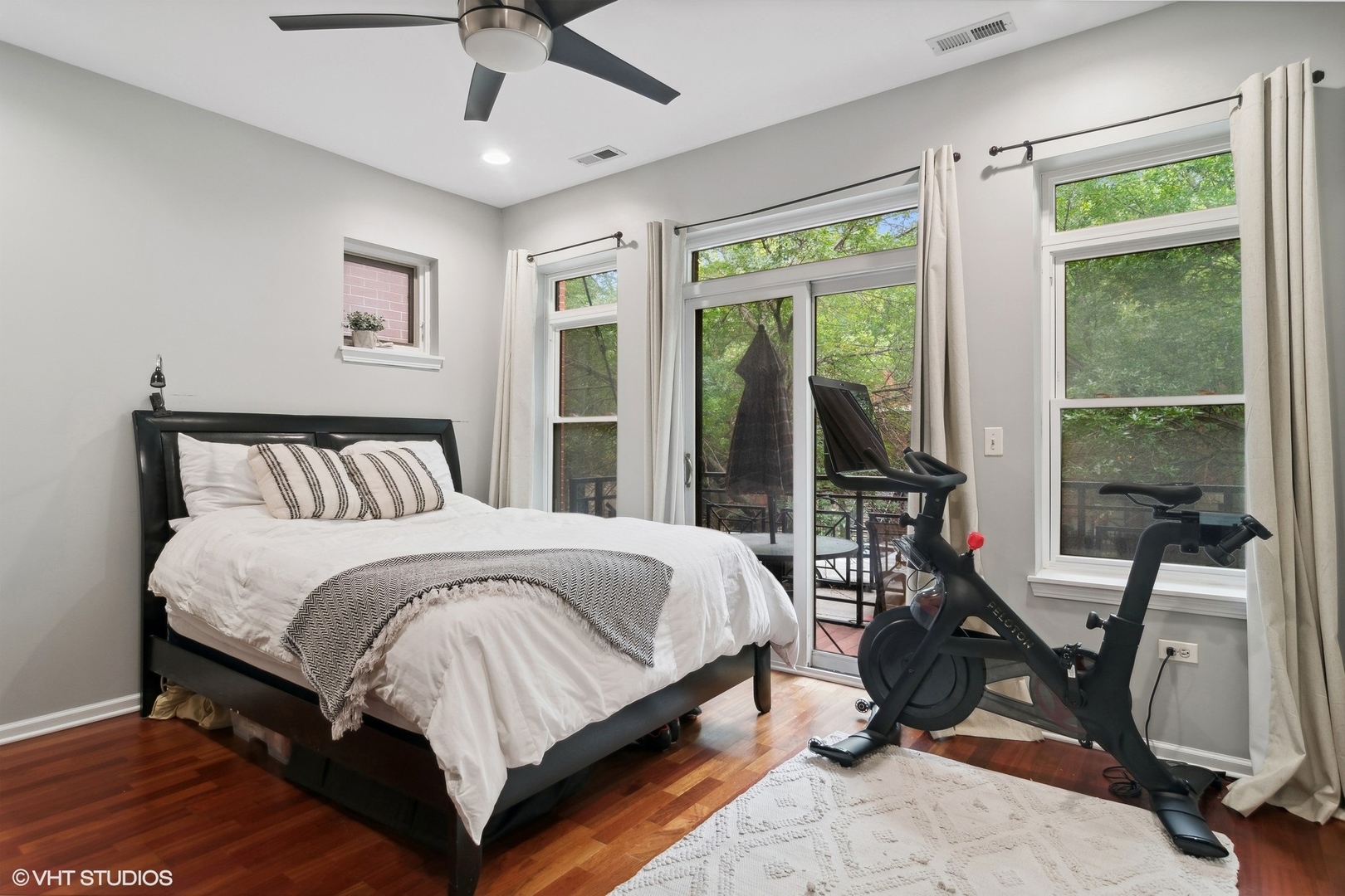 1451 South Halsted Street, Unit 2A Chicago, IL 60607 - Photo 6 of 10 a bedroom with a bed a large window and furniture