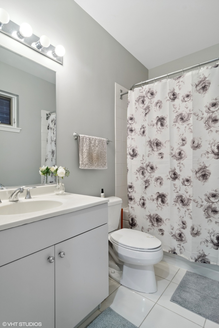 1451 South Halsted Street, Unit 2A Chicago, IL 60607 - Photo 7 of 10 a bathroom with a sink toilet and shower