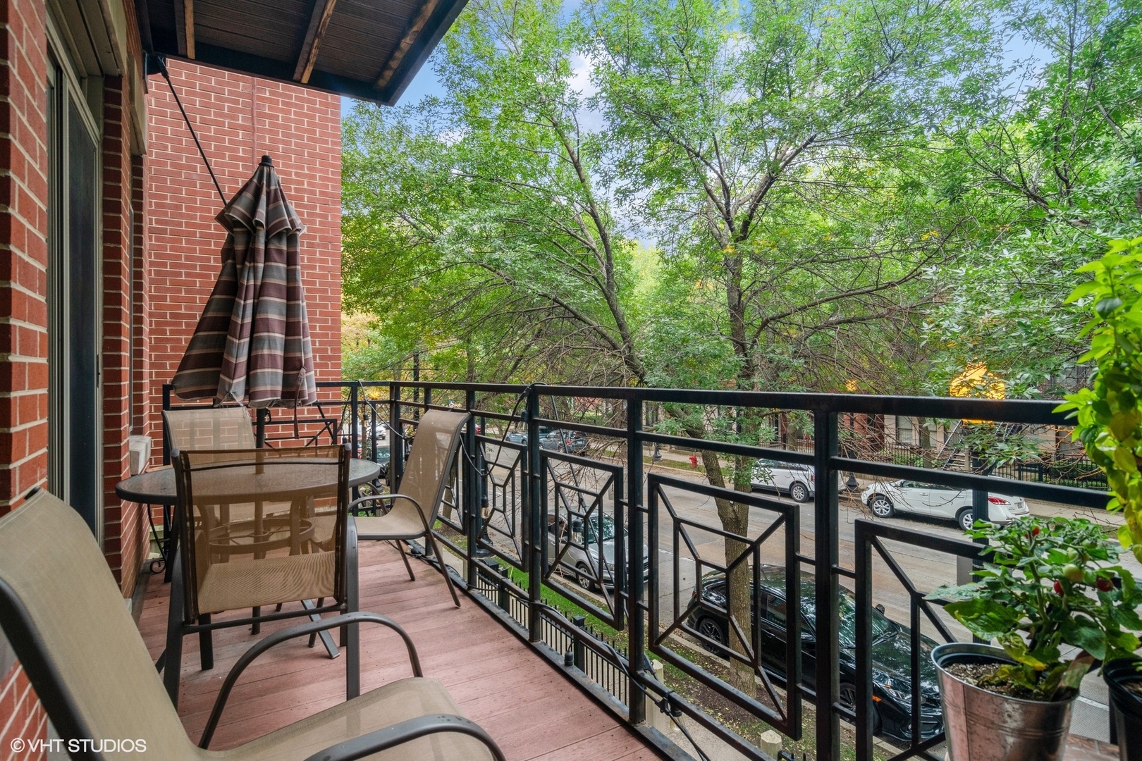 1451 South Halsted Street, Unit 2A Chicago, IL 60607 - Photo 10 of 10 a view of a balcony with chairs and wooden fence