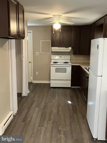 a kitchen with a refrigerator and a stove