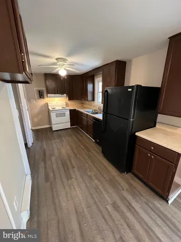 a kitchen with a refrigerator and a sink