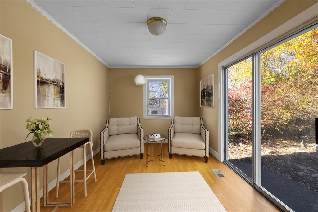 51 Appleton Street Saugus, MA 01906 - Photo 8 of 17 a living room with furniture and a floor to ceiling window