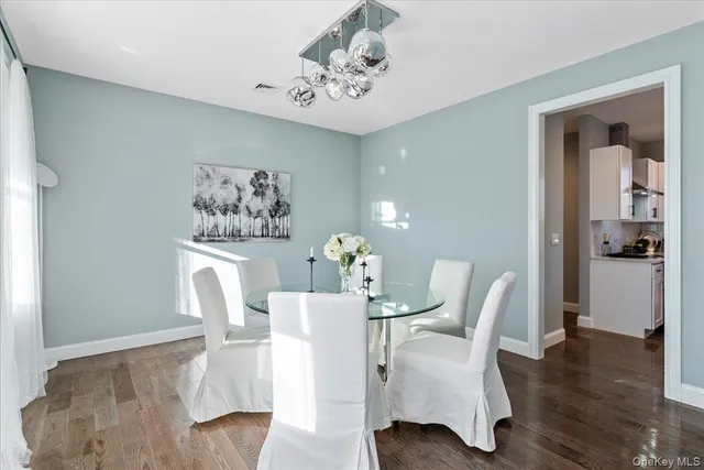 a dining room with furniture and wooden floor