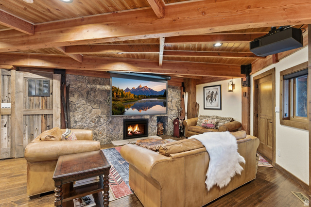 2687 Stewart Road Sundance, UT 84604 - Photo 18 of 48 Home theater with a fireplace, a wooden ceiling with exposed beams, wood finished floors, and recessed lighting