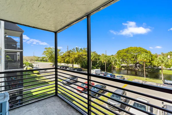 a view of a room with wooden floor and ceiling fan