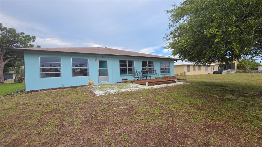 199 Caddy Road Rotonda West, FL 33947 - Photo 20 of 20 a view of an house with backyard and trees