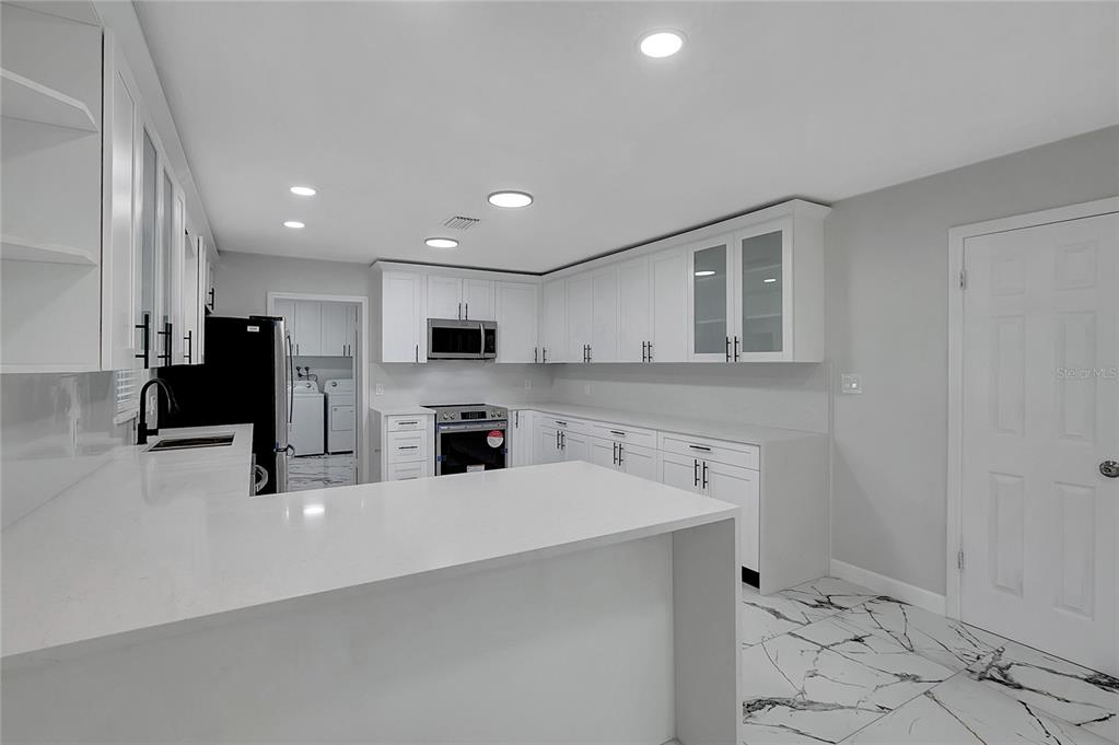 604 Druid Hills Road Temple Terrace, FL 33617 - Photo 16 of 59 a kitchen with stainless steel appliances a refrigerator sink and microwave