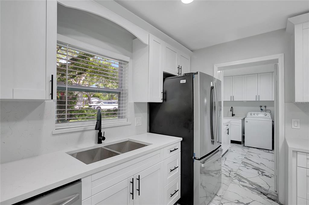 604 Druid Hills Road Temple Terrace, FL 33617 - Photo 19 of 59 a kitchen with a refrigerator and a sink
