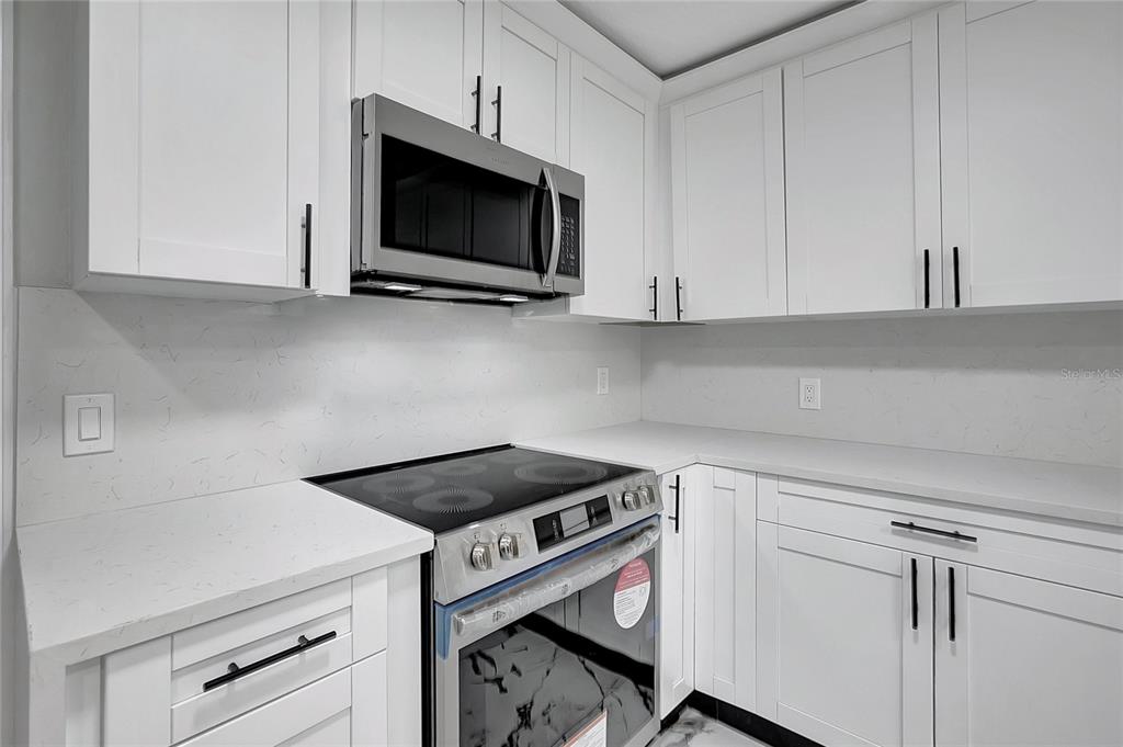 604 Druid Hills Road Temple Terrace, FL 33617 - Photo 20 of 59 a kitchen with a stove and a microwave
