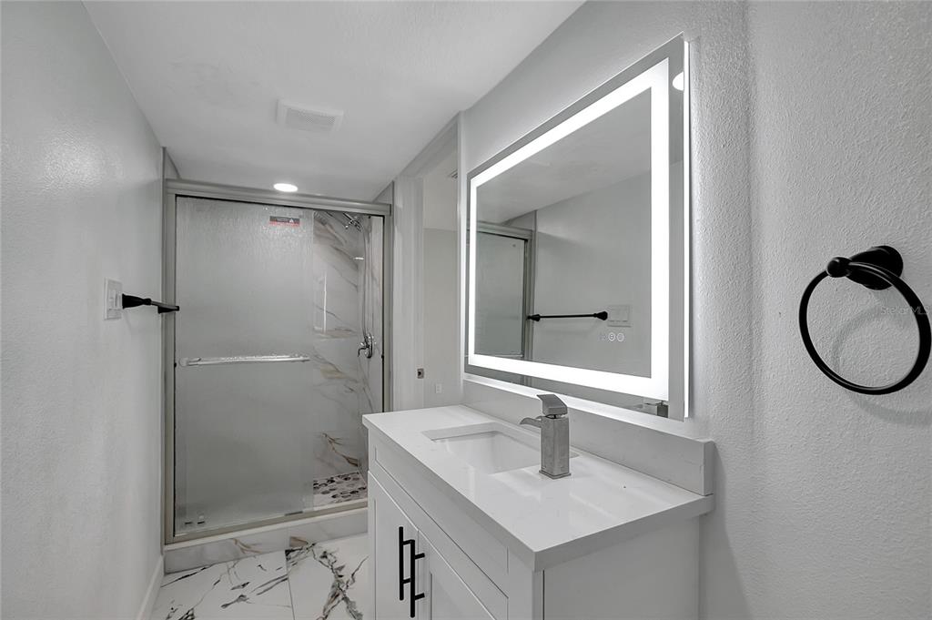 604 Druid Hills Road Temple Terrace, FL 33617 - Photo 27 of 59 a bathroom with a sink vanity mirror and shower