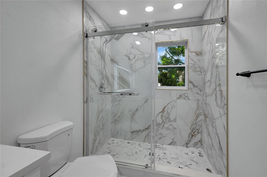 604 Druid Hills Road Temple Terrace, FL 33617 - Photo 34 of 59 a bathroom with a shower and a toilet