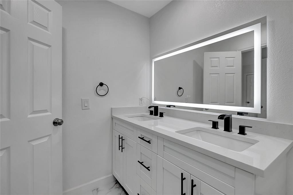 604 Druid Hills Road Temple Terrace, FL 33617 - Photo 35 of 59 a bathroom with a double vanity sink mirror and