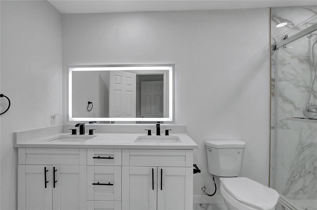 604 Druid Hills Road Temple Terrace, FL 33617 - Photo 36 of 59 a bathroom with a toilet sink vanity and mirror