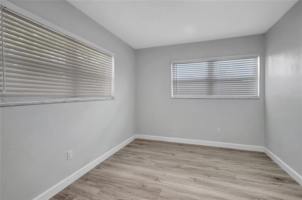 604 Druid Hills Road Temple Terrace, FL 33617 - Photo 37 of 59 a view of an empty room with wooden floor and a window