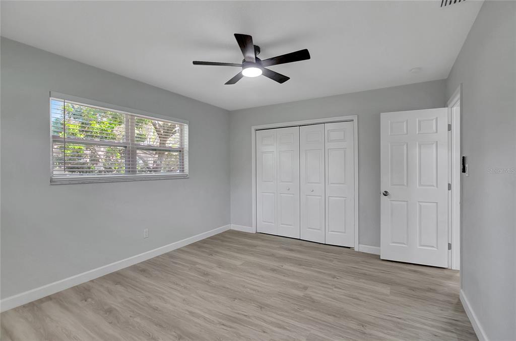 604 Druid Hills Road Temple Terrace, FL 33617 - Photo 43 of 59 a view of empty room with wooden floor and fan