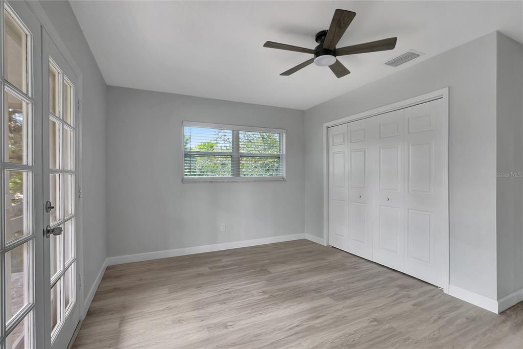 604 Druid Hills Road Temple Terrace, FL 33617 - Photo 47 of 59 a view of empty room with wooden floor and fan