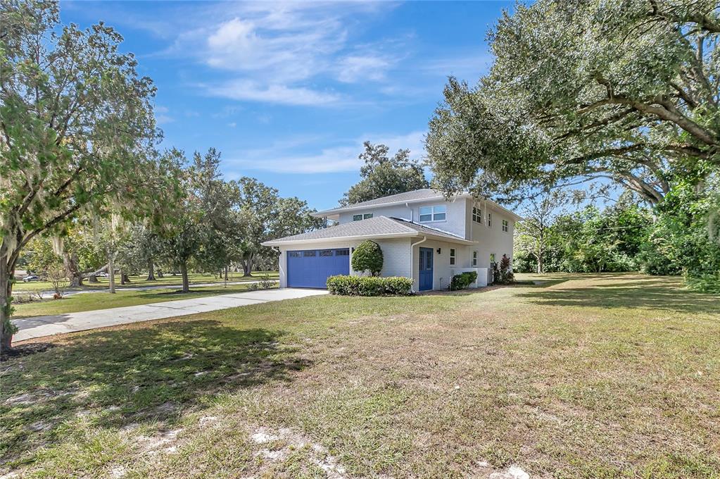 604 Druid Hills Road Temple Terrace, FL 33617 - Photo 56 of 59 a front view of a house with a yard and garage