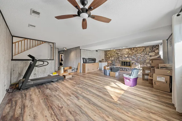 a room with gym equipment and a wooden floor