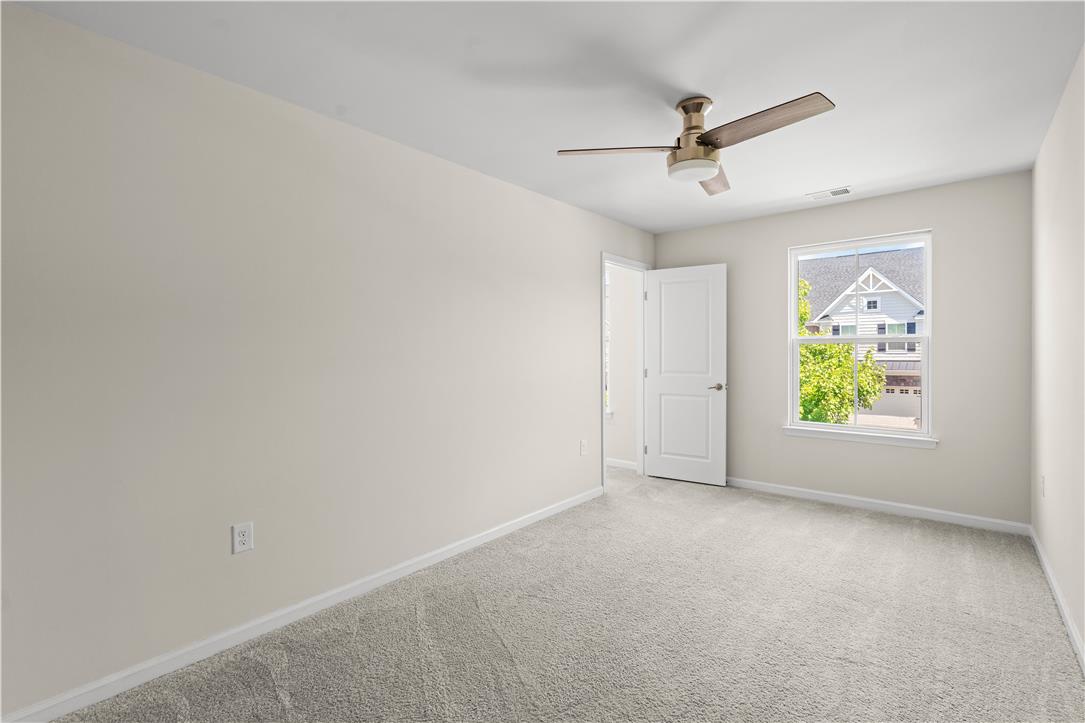 4758 Rafi Road Easton, PA 18045 - Photo 32 of 55 A well-lit bedroom with soft carpeting and a ceiling fan offers a comfortable living space.