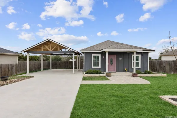 a front view of a house with a yard and porch