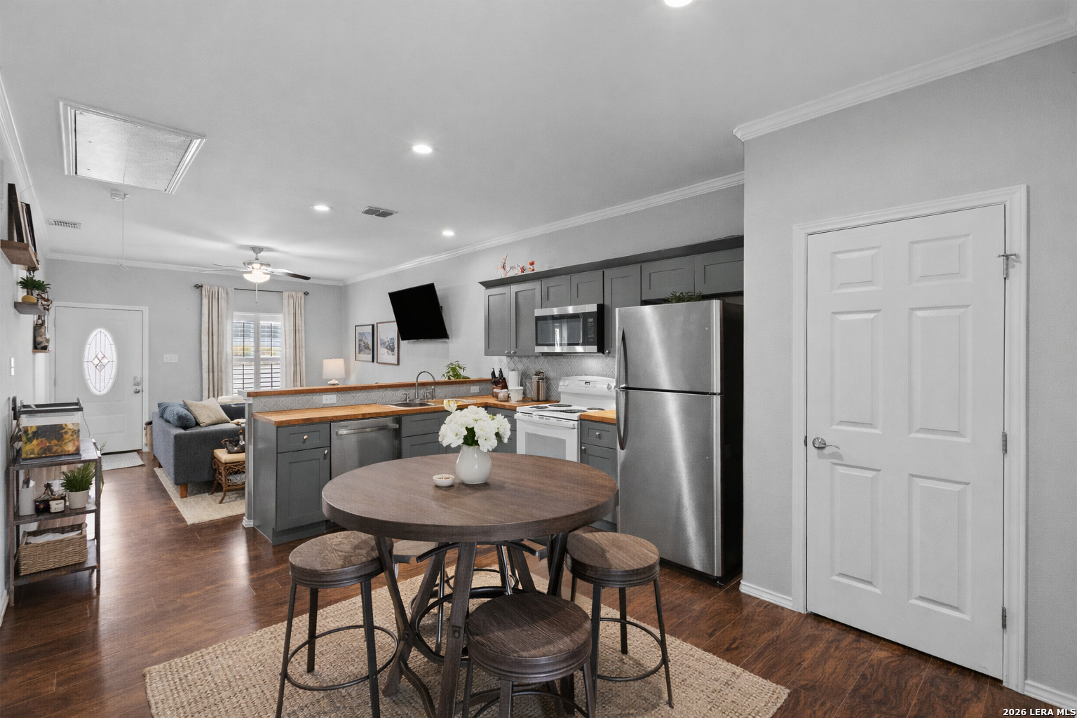 441 Cimarron Spring Branch, TX 78070 - Photo 6 of 20 a kitchen with a dining table cabinets appliances and wooden floor