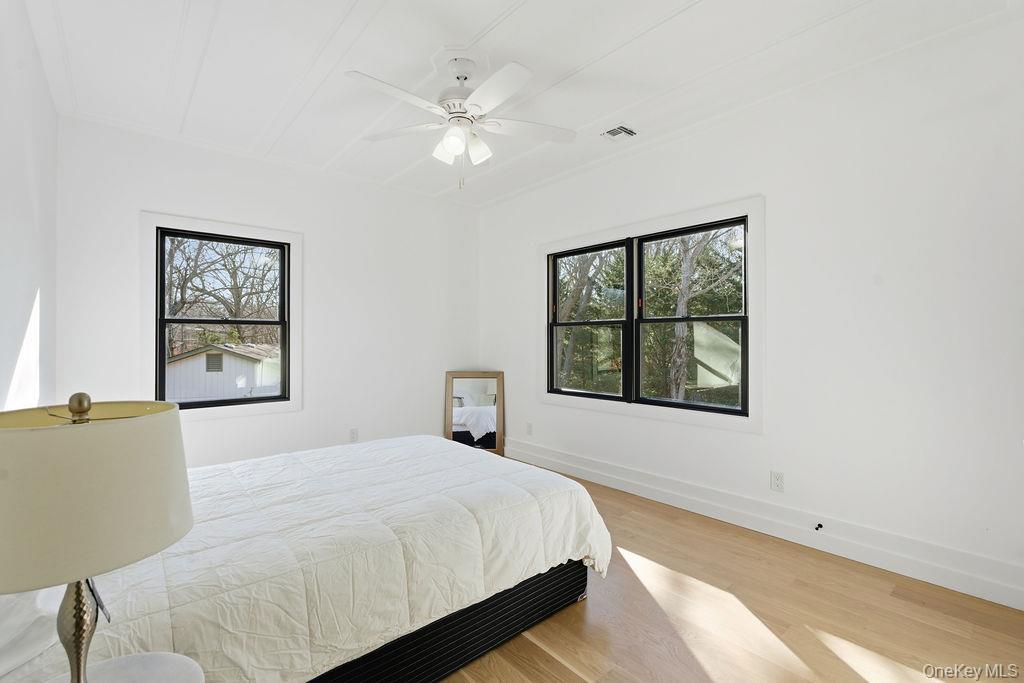768 Bridgehampton Sag Harbor Bridgehampton, NY 11932 - Photo 24 of 35 Bedroom with light wood-style flooring and a ceiling fan