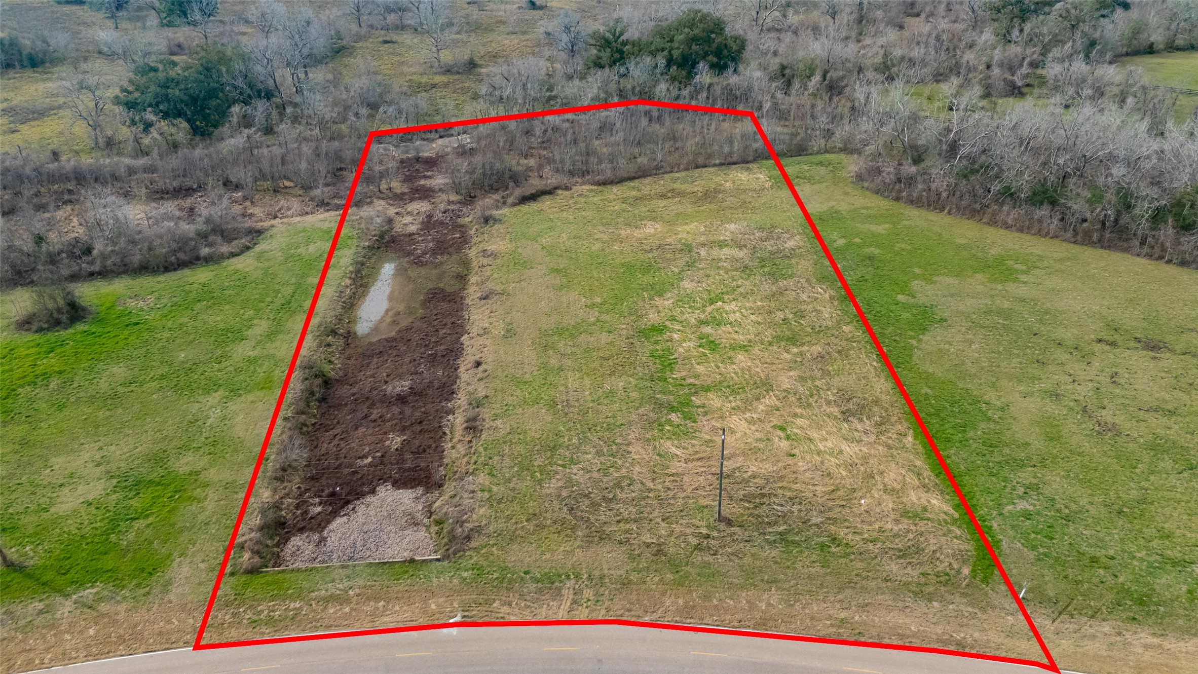 22802 Pittman Drive Angleton, TX 77515 - Photo 2 of 9 Aerial view with approximate property lines outlined, showcasing the full 3.182-acre homesite, open pasture build area, and paved roads