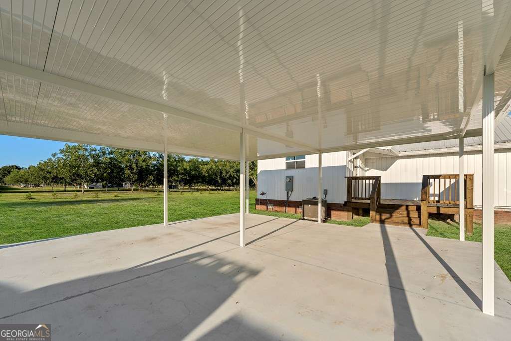 1335 Clifford Loop Blackshear, GA 31516 - Photo 20 of 43 a view of a patio with a table chairs and a patio