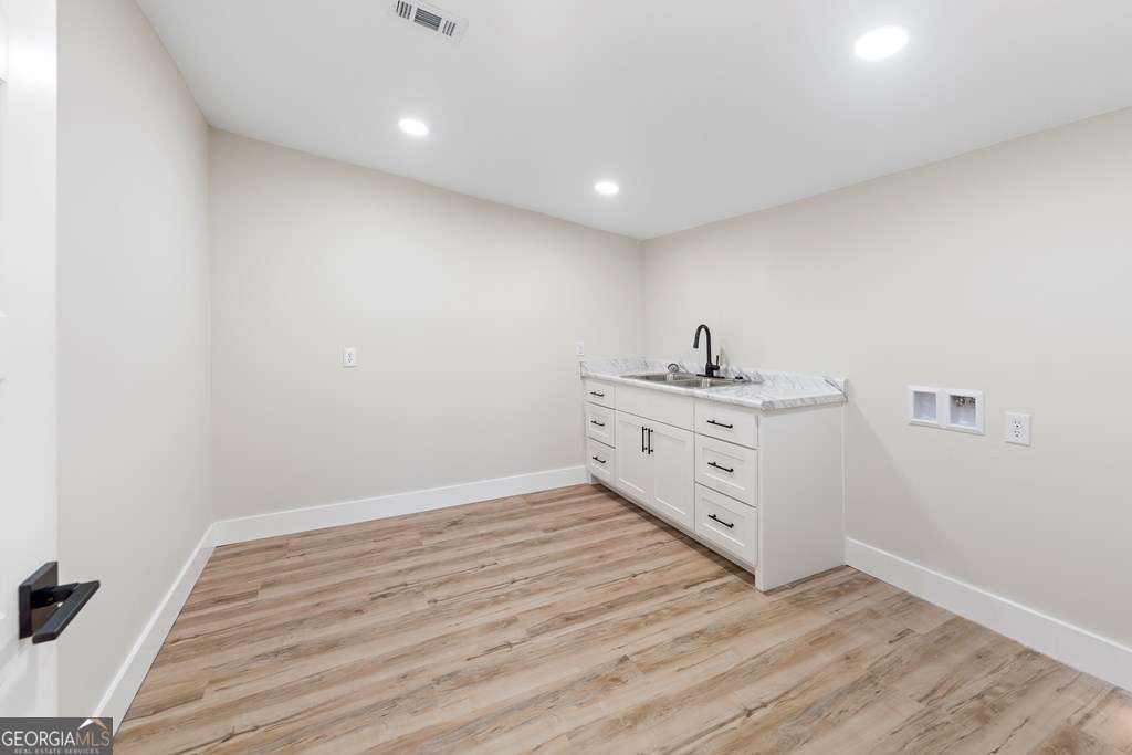 1335 Clifford Loop Blackshear, GA 31516 - Photo 29 of 43 a kitchen with a sink and cabinets