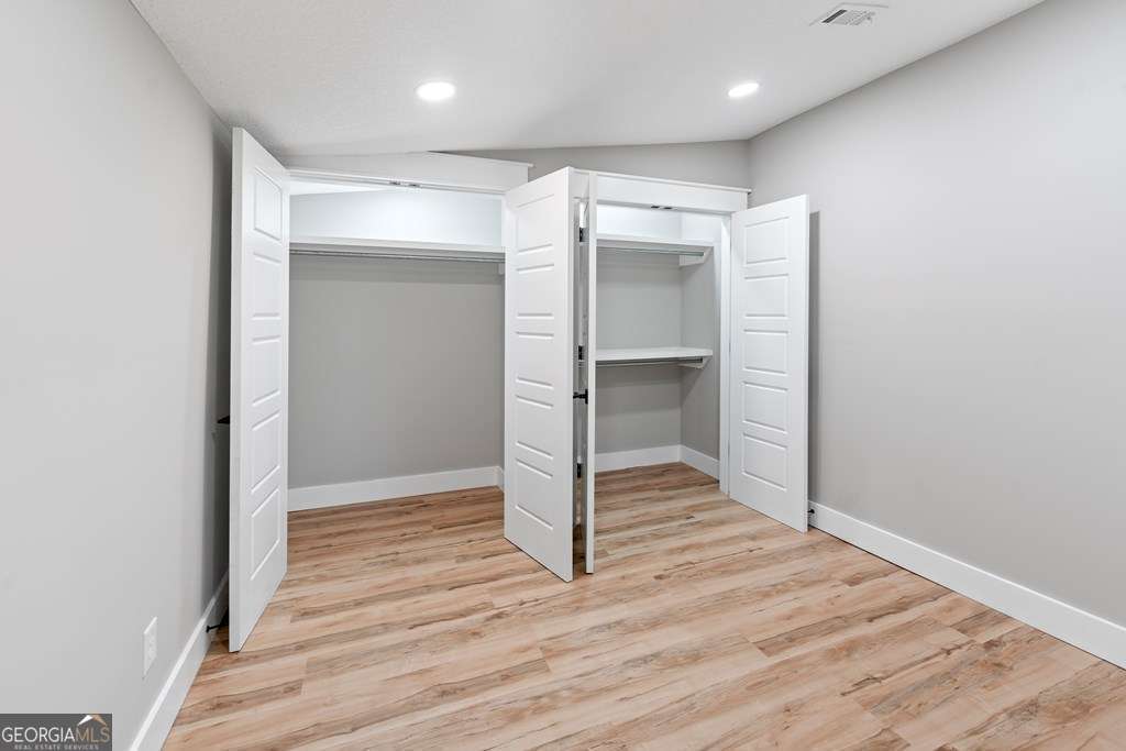 1335 Clifford Loop Blackshear, GA 31516 - Photo 30 of 43 a view of empty room with wooden floor