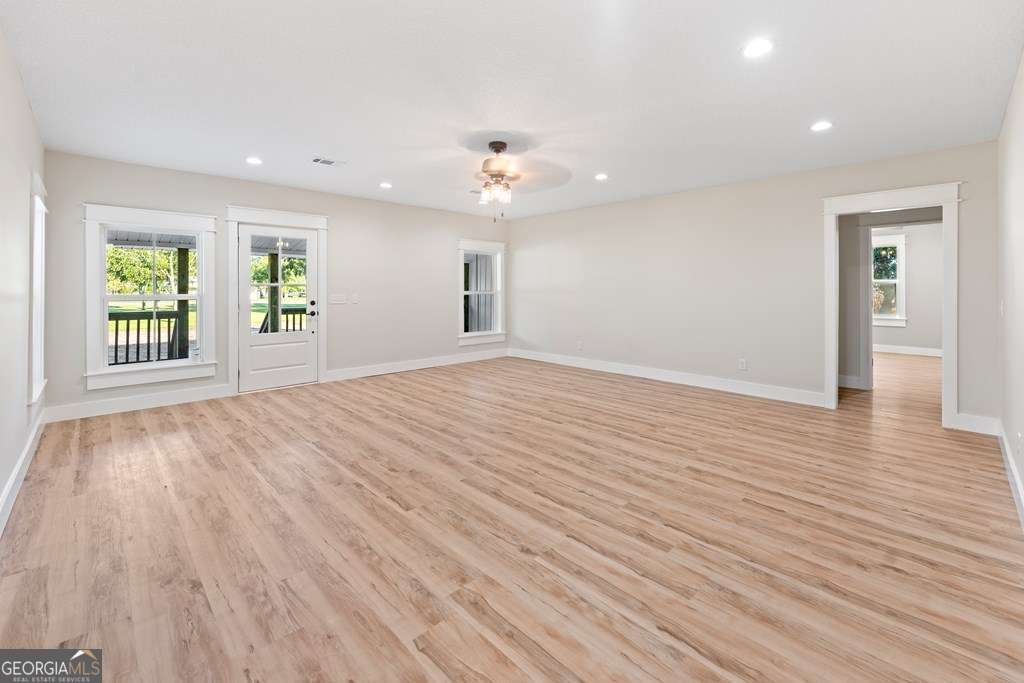 1335 Clifford Loop Blackshear, GA 31516 - Photo 31 of 43 a view of an empty room with wooden floor and a window