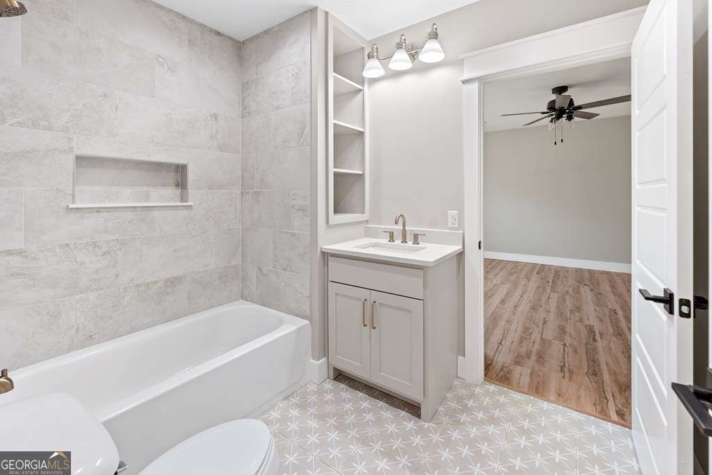 1335 Clifford Loop Blackshear, GA 31516 - Photo 33 of 43 a bathroom with a sink a toilet and bathtub