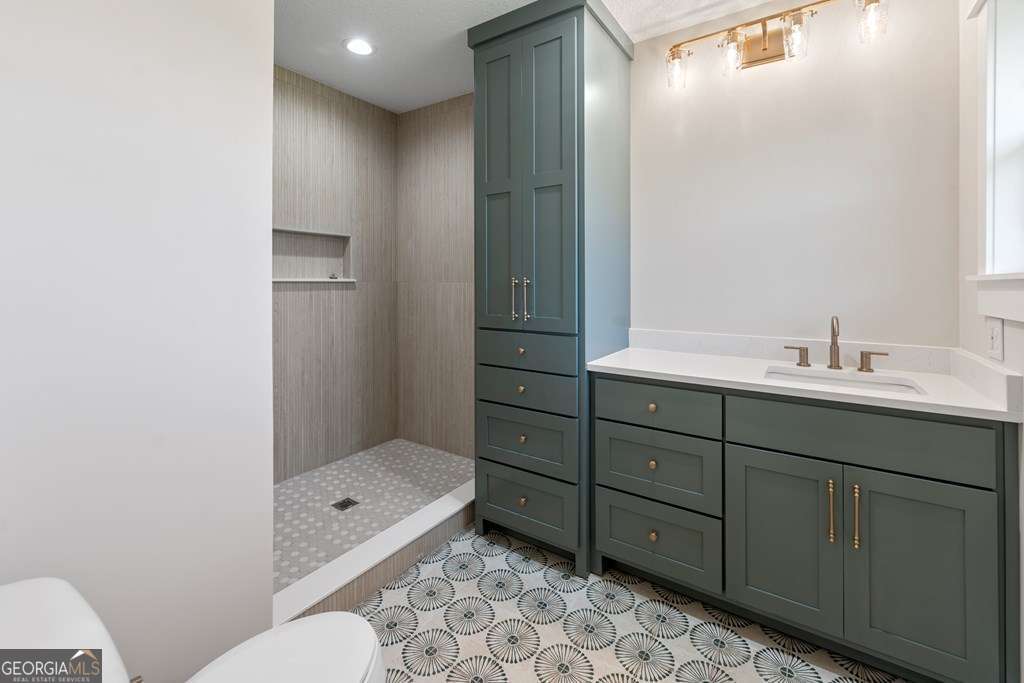 1335 Clifford Loop Blackshear, GA 31516 - Photo 40 of 43 a bathroom with a double vanity sink mirror toilet and bathtub