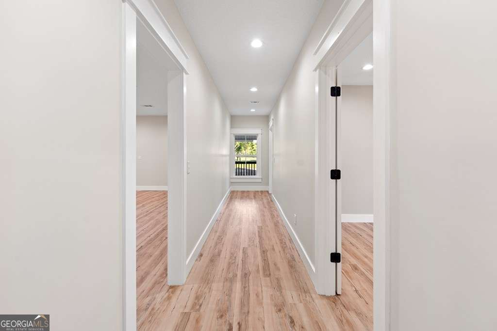 1335 Clifford Loop Blackshear, GA 31516 - Photo 41 of 43 a view of a hallway with wooden floor and staircase