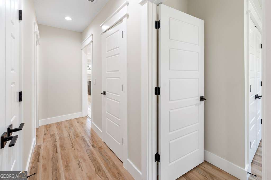 1335 Clifford Loop Blackshear, GA 31516 - Photo 42 of 43 a view of a hallway with wooden floor and staircase