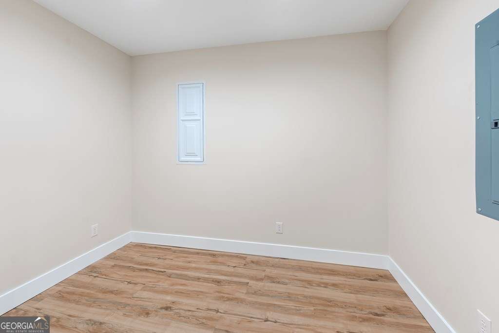 1335 Clifford Loop Blackshear, GA 31516 - Photo 43 of 43 a view of an empty room with wooden floor and a window