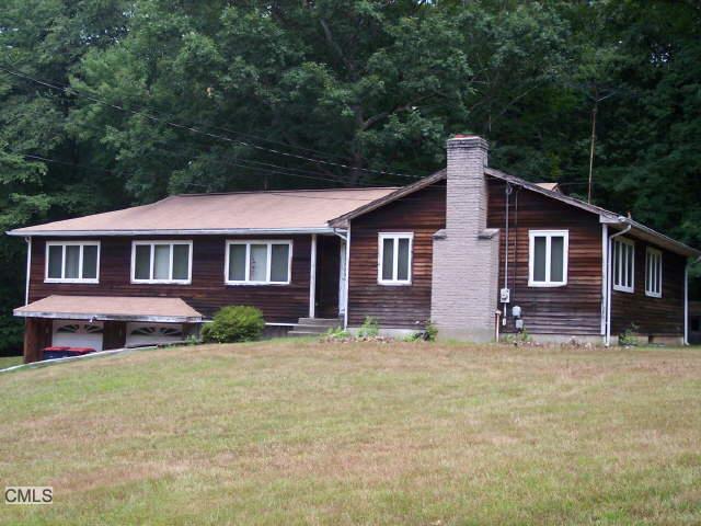 123 Oldfield Road Trumbull, CT 06611 - Photo 1 of 1 a front view of a house with a garden
